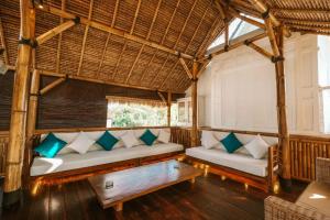 a living room with two couches and a table at The Palms Canggu in Canggu