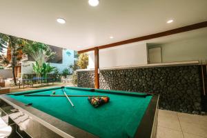 a pool table in the middle of a room at The Palms Canggu in Canggu