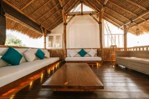 a living room with couches and a coffee table at The Palms Canggu in Canggu +37 photos
