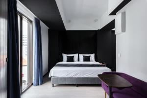 a bedroom with a large bed with black walls at Loop On Leith George Town Penang Hotel in George Town