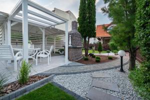a patio with a fireplace and a table and chairs at Domki Wioska Rybacka in Hel