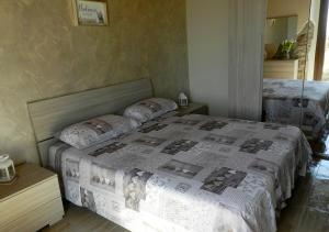 Postel nebo postele na pokoji v ubytování B&B GLI ULIVI