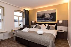 Säng eller sängar i ett rum på Hotel Sylter Hof