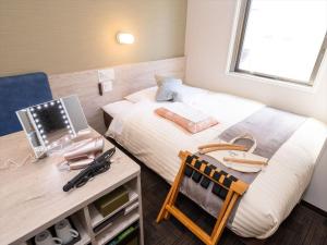 Postel nebo postele na pokoji v ubytování Super Hotel Premier Saitama Higashiguchi