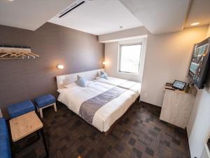 Postel nebo postele na pokoji v ubytování Super Hotel Premier Saitama Higashiguchi