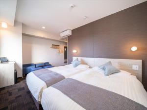Postel nebo postele na pokoji v ubytování Super Hotel Premier Saitama Higashiguchi