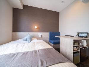 Postel nebo postele na pokoji v ubytování Super Hotel Premier Saitama Higashiguchi
