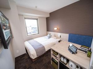 Postel nebo postele na pokoji v ubytování Super Hotel Premier Saitama Higashiguchi