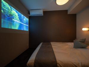 Postel nebo postele na pokoji v ubytování Super Hotel Premier Saitama Higashiguchi