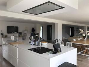 a kitchen with a white counter top in a room at Villa les Pierres d'Antan in Lorgues