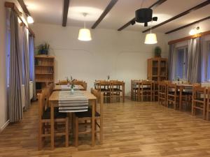 a dining room with wooden tables and chairs at Belvederská chalupa in Železná Ruda