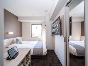 Postel nebo postele na pokoji v ubytování Super Hotel Premier Saitama Higashiguchi