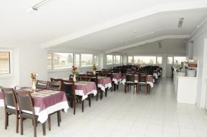 a dining room with tables and chairs in a restaurant at Hotel Kuk in Istanbul