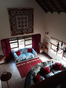 a living room with a couch and a red rug at Happy Jackal Guest House in Colchester