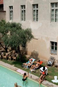 a group of people laying around a swimming pool at Castello Di San Sebastiano Po in Chivasso