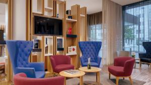 a living room filled with furniture and a tv at Holiday Inn Frankfurt - Alte Oper, an IHG Hotel in Frankfurt