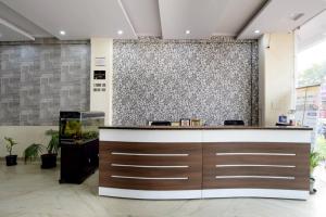 a lobby with a reception desk in a building at Hotel Sky Inn in Jaipur +13 photos