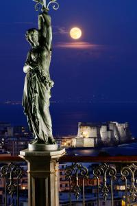 a statue on top of a building with a full moon at Grand Hotel Parker's in Naples