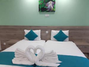 a bed with two white pillows and a white pillow on it at TJ Boutique in Marsaskala
