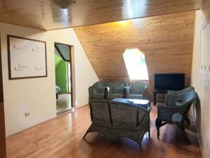 a room with chairs and a table and a television at Qingjing Xiaozhu in Renai