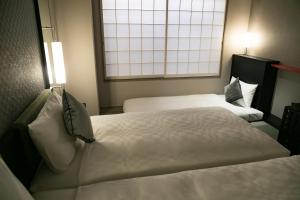 Postelja oz. postelje v sobi nastanitve Hotel Resol Trinity Kyoto