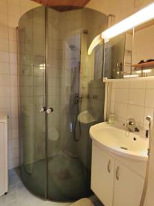 a bathroom with a shower and a sink at Very Lovely Apartment in city center in Helsinki