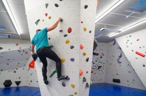 a man is climbing a rock wall on a climbing wall at Jugend- und Familiengästehaus Klagenfurt in Klagenfurt