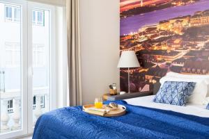 Cette chambre comprend un lit bleu et un plateau/bouilloire. dans l'établissement ALTIDO Chic studio in Principe Real, nearby Botanical Garden of Lisbon, à Lisbonne
