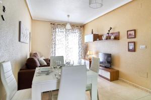 a living room with a white table and a couch at Espanhouse La Zenia 109 in Orihuela Costa