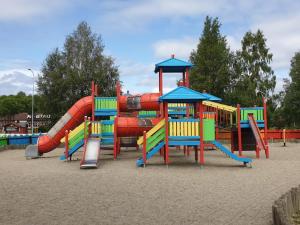 a playground with a colorful slide and slides at Jämtkrogen Hotell in Bräcke