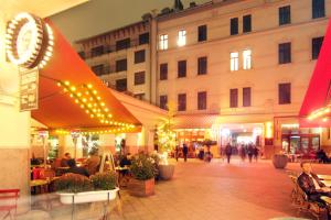 a group of people walking around a shopping mall at Hotel Gozsdu Court in Budapest