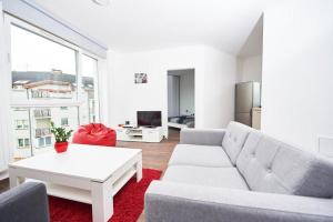 a living room with a couch and a table at Cube Apartamenty in Lublin