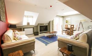 a living room with two couches and a fireplace at Seagull's Sanctuary in Wells next the Sea