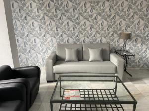 a living room with a couch and a wall mural at Apartamentos Avenida in Seville