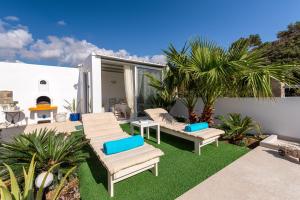 patio z leżakami i kominkiem w obiekcie Secret Paradise w mieście Koutsounari