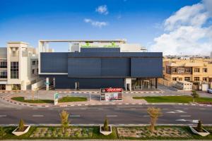 an empty parking lot in front of a building at Lemon Tree Hotel, Jumeirah Dubai in Dubai