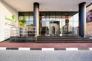 a building with stairs in front of a building at Lemon Tree Hotel, Jumeirah Dubai in Dubai