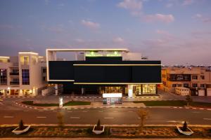 a large building in a city with a parking lot at Lemon Tree Hotel, Jumeirah Dubai in Dubai