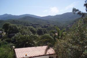 a view of the mountains from a house at Villa Solsticia in Porticcio