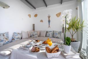 a living room with a table with food on it at Secret Paradise in Koutsounari