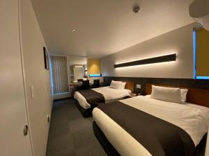 Voodi või voodid majutusasutuse Hotel 草石庵 toas
