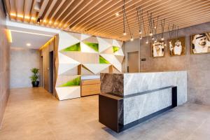 a lobby with a reception desk in a building at Lemon Tree Hotel, Jumeirah Dubai in Dubai