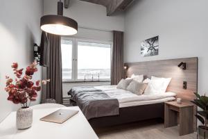 a bedroom with a bed and a desk with a laptop at Forenom Hotel Arlanda in Arlanda