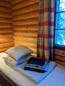 Un pat sau paturi într-o cameră la Tunturioravat