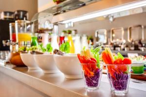 a counter with three cups filled with vegetables on it at Lemon Tree Hotel, Jumeirah Dubai in Dubai