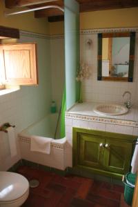 a bathroom with a tub and a sink and a toilet at El Canto del Gallo in Ranedo de Curueño