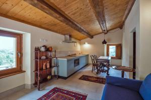 a kitchen and living room with a couch and a table at Appartamento Loretello in Arcevia