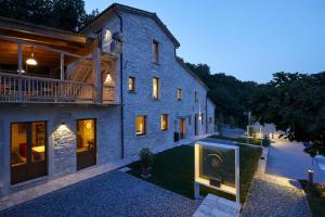 a large blue building with a balcony and a house at Appartamento Nidastore in Arcevia