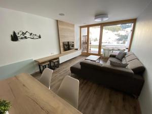 a living room with a couch and a table at Apartment Andrea in Maria Alm am Steinernen Meer