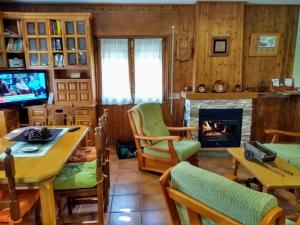 sala de estar con chimenea y TV en Tinao de Gredos, en Barajas de Gredos